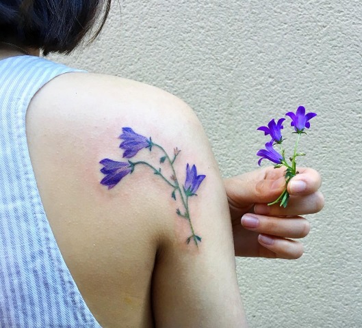 Artistic bluebell flower tattoo on the shoulder