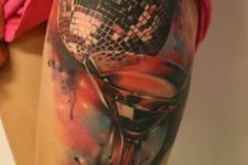 Big tattoo with disco ball and cocktail glass