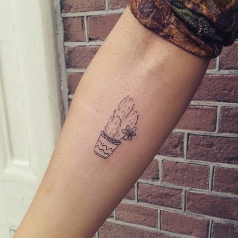 Black-contour tattoo on the arm