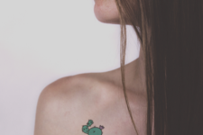 Cartoon cactus tattoo on the shoulder