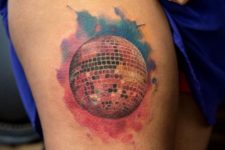 Colorful disco ball tattoo on the leg