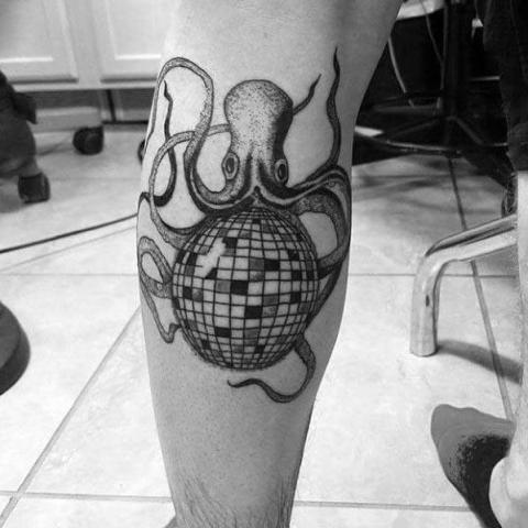 Disco ball and octopus tattoo on the leg