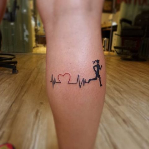 Heartbeat and running woman tattoo on the leg