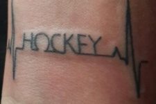 Heartbeat with a word hockey tattoo on the wrist