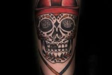 Hockey themed tattoo with a skull