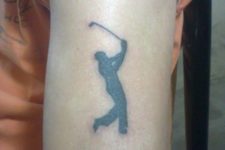 Small black golf player tattoo on the arm
