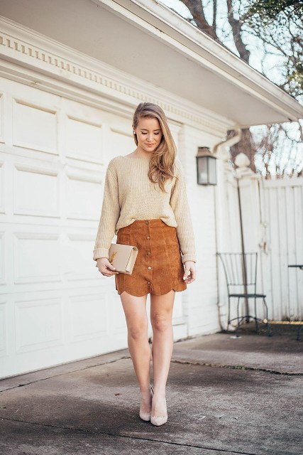 With beige sweater, leather clutch and pumps