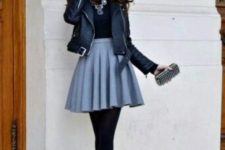 With black shirt, leather jacket, high heels and mini clutch