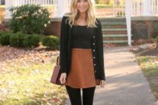 With black top, black cardigan, brown bag and lace up boots