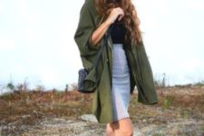 With black top, white and black sneakers, black crossbody bag and olive green long shirt