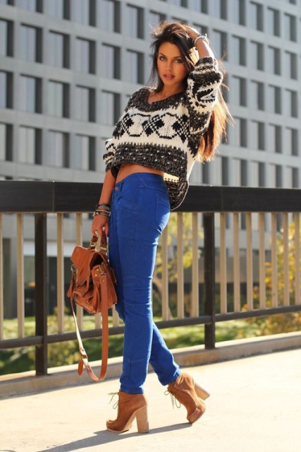 With blue pants, lace up boots and brown bag