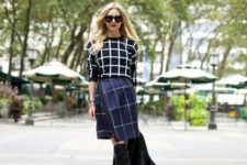 With checked shirt, black tote and black high boots
