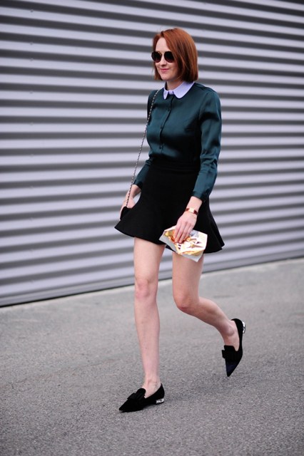 With emerald blouse, flat shoes and chain strap bag