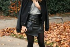 With gray t-shirt, black bomber jacket, black clutch and boots