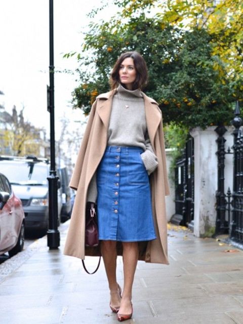 With gray turtleneck sweater, camel coat and pumps
