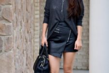 With loose shirt, black pumps and black leather bag