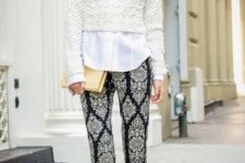 With printed trousers, white shirt, beige clutch and white shoes