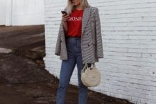 With red t-shirt, tweed jacket, jeans and round bag