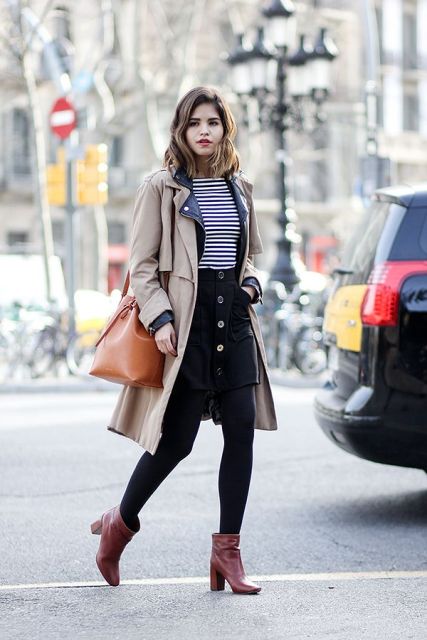With striped shirt, trench coat, brown bag and boots