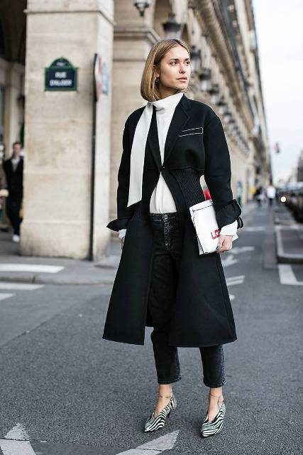 With white shirt, black coat, jeans and white clutch