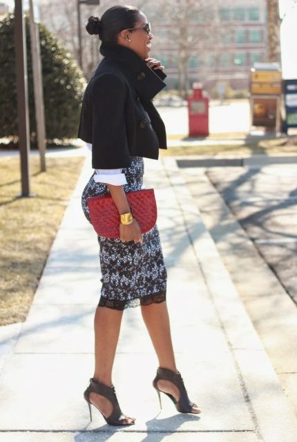 With white shirt, black crop jacket, red clutch and cutout shoes