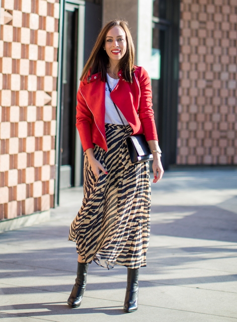 With white t-shirt, red jacket, crossbody bag and leather boots
