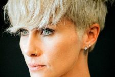 a blonde layered pixie with a longer top and front cut in layers and outgrown fringe is a catchy and rock-style idea