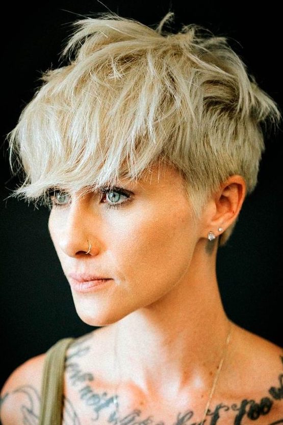 A blonde layered pixie with a longer top and front cut in layers and outgrown fringe is a catchy and rock style idea