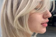 a chic icy blonde long bob with curtain bangs is a very cool idea that feels modern and edgy