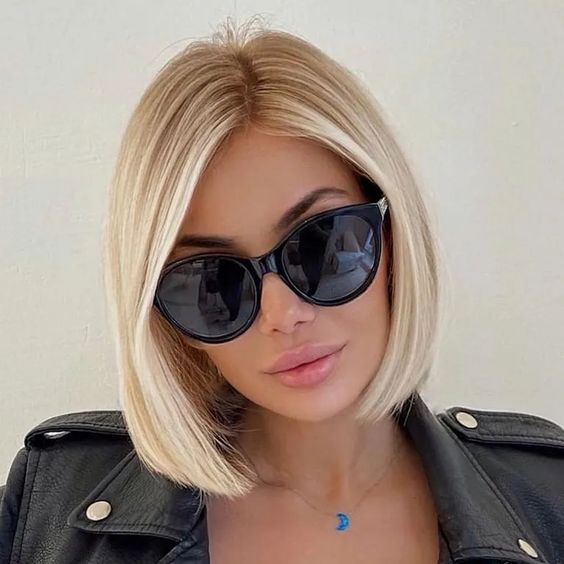 A classic chin length creamy blonde bob with a lot of volume and side parting is a cool and catchy idea