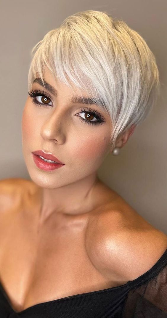 a gorgeous platinum blonde long pixie with side bangs is a cool and chic idea to look refined