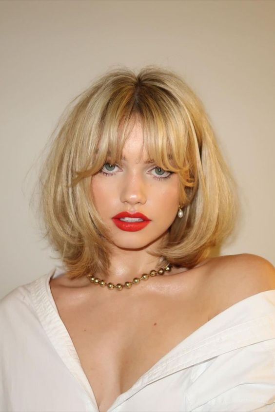 a long golden blonde bob to buterfly, with bottleneck bangs and curled ends looks very sexy and feminine