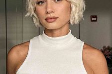 a messy and textured layered jaw-line bob in a pretty bleached blonde shade is a super cool and catchy idea