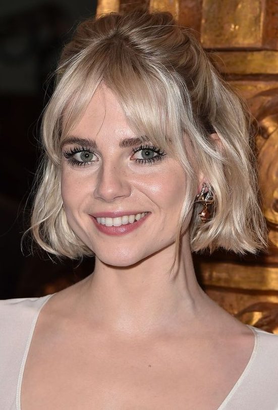 A platinum blonde chin length bob with curtain bangs and waves styled as a half updo is a catchy idea