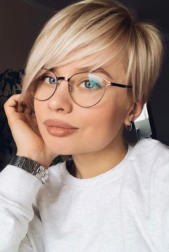 a straight long blonde pixie haircut with side parting and volume looks very chic and modern