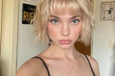 a textural and layered creamy blonde bob with a classic fringe is a cool and cute idea to rock