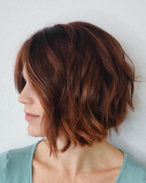 an asymmetrical mid bob with highlights and waves, with a lot of volume, is a chic and cool idea, and volume adds interest to it