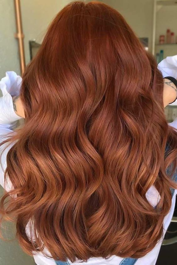 beautiful long auburn hair with waves and a lot of volume will make a statement in your fall look