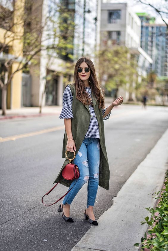 blue ripped skinnies with a raw hem, a gingham shirt, a green long waistcoat, kitten heels and a red bag