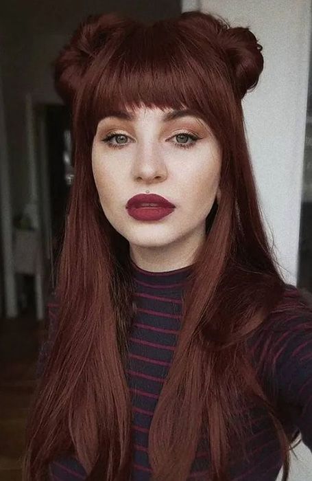 gorgeous dark auburn hair styled as a half updo, with top knots and straight hair down, with a classic fringe and some volume