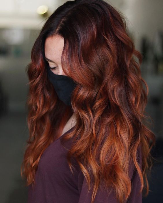 jaw-dropping long auburn hair, with a slight ombre effect, volume and waves, is a fantastic idea that will make you stand out a lot