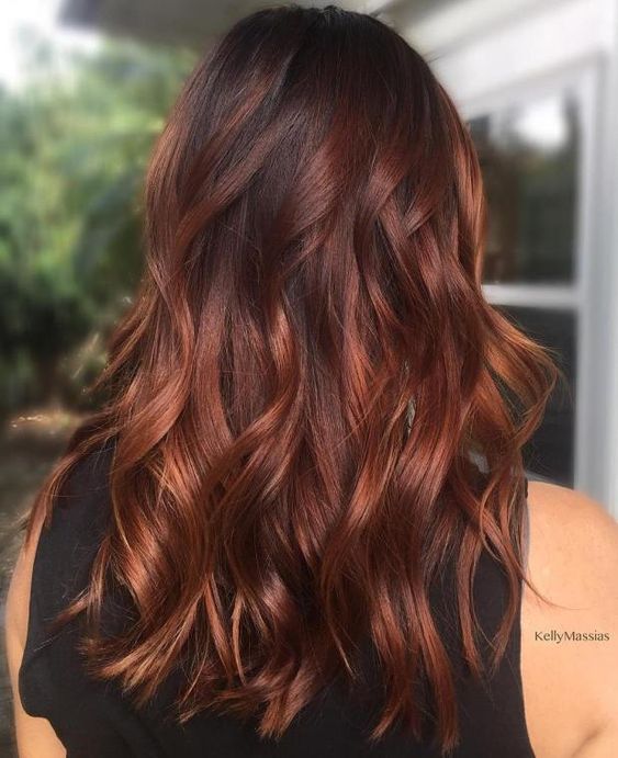jaw-dropping long black hair with auburn highlights and waves is always a good idea, it looks very contrasting and stunning