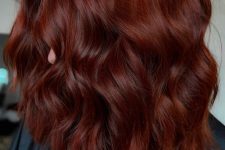 jaw-dropping medium-length auburn hair with a lot of volume and waves is a fantastic idea for the fall