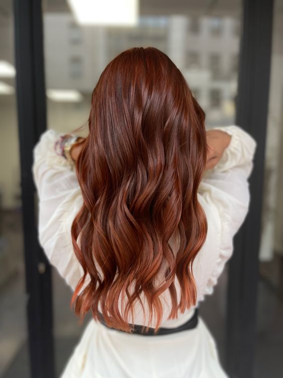 long and pretty auburn hair with waves and a bit of volume is always a stylish and cool idea to try