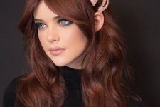long auburn hair with a lot of volume and waves, curtain bangs and pink hairpins is a gorgeous solution to rock