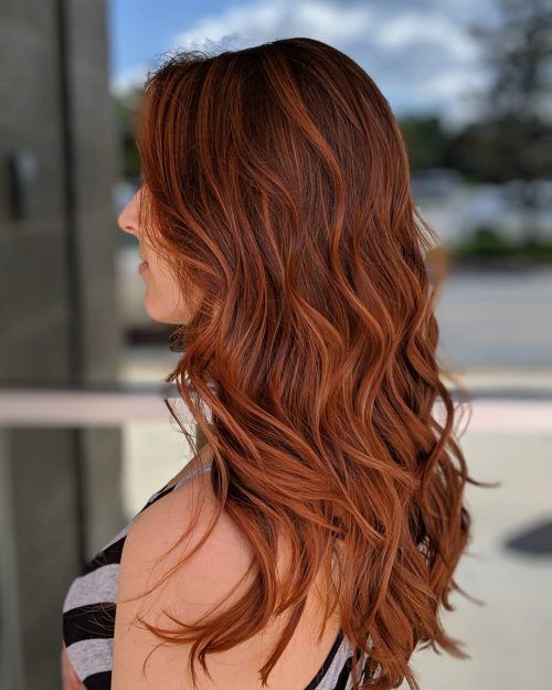 long auburn hair with copper highlights, with volume and waves, is a stunning solution to rock,
