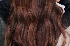 long black hair with auburn highlights, with a lot of volume and waves, is a stunning idea for the fall