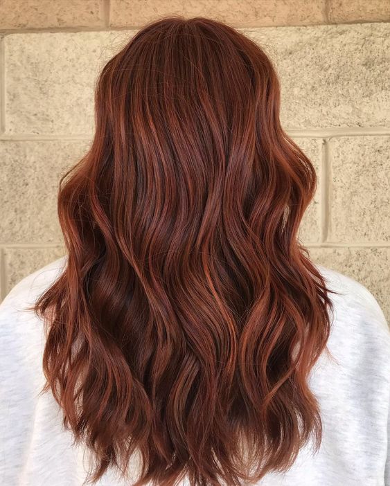 lovely long auburn hair with a lot of volume and waves is a catchy and cool idea, it looks absolutely adorable