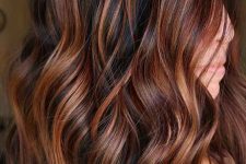 medium-length black hair with bold auburn balayage and waves is a fantastic idea, it will add interest to your looks