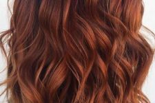 shoulder-length auburn hair with a shadow root, with volume and waves, is a stunning idea to rock in the fall